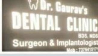Dr. Gaurav's Dental & Implant Clinic illuminated entrance sign